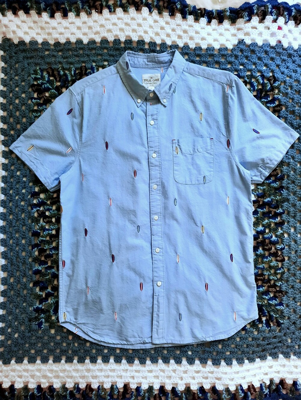 TRUE GRIT Surfboards on Light Blue Short Sleeve Collared Shirt. Pocket